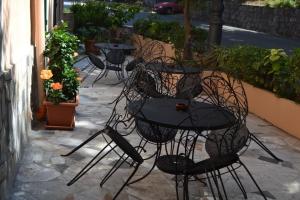 a group of tables and chairs on a patio at B&B HF Fiorella in Maratea