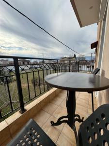 a table and chairs on a balcony with a view at Forest trikala view in Tríkala