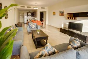 a large living room with couches and a table at Shoreline Apartment - Tala Bay in Aqaba