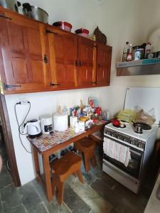 a small kitchen with a table and a stove at Mike's Cycladic Villa in Poros