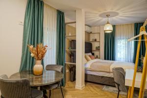 a bedroom with a bed and a table with a tableablish at The Miracle in Bucharest