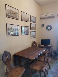 a dining room with a wooden table and chairs at Mike's Cycladic Villa in Poros