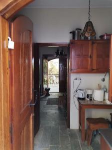 a kitchen with an open door and a hallway at Mike's Cycladic Villa in Poros