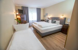 Postel nebo postele na pokoji v ubytování Hotel Altmünchen by Blattl