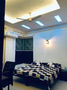 a bedroom with a black and white checkered bed at StayHolic in Ghaziabad