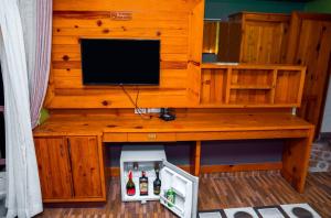 a wooden desk with a television on top of it at Hotel Kamana in Pokhara