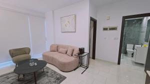 a living room with a couch and a chair and a table at STAY Cosmo City Suites in Nicosia