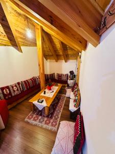 a living room with couches and a wooden table at Kore Guest House in Gjirokast&euml;r