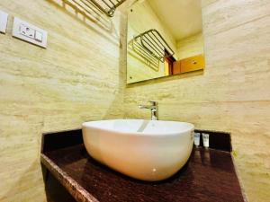 y baño con lavabo blanco y espejo. en Hotel Ultra International, en Bhairāhawā