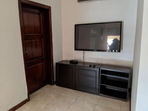 a living room with a flat screen tv on a wall at Beautiful Home In Secure Township in Accra