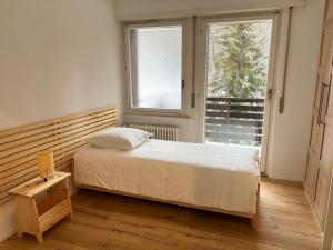 a small bedroom with a bed and a window at The Fit’ house in Crans-Montana