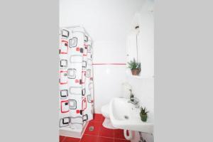 a bathroom with a sink and a shower curtain at LEFKES Apartments Sidari in Sidari