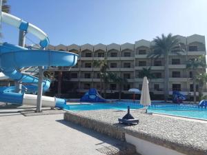 a water slide in front of a resort pool at hurghada - chalet - in Hurghada