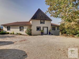 a house with a gravel driveway in front of it at La Tourelle du Lot in Cajarc