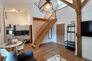 a living room with a staircase and a dining room at NEU! Ferienwohnung Junge 1 in Lohe-Rickelshof