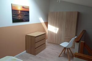 a bedroom with a desk and a chair and a cabinet at NEU! Ferienwohnung Junge 1 in Lohe-Rickelshof