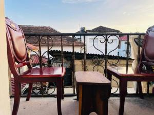 two chairs and a table on a balcony at Pazuri apartment in Ngambo