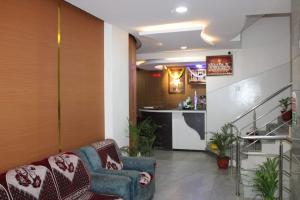 a living room with a couch and a bar at MALDIVES INN in Bengaluru