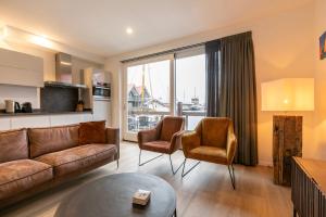 a living room with a couch and two chairs at Summio Havenresort Terherne in Terherne