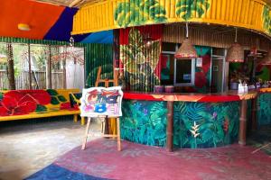 a colorful bar in a room with a table at Chaba Bungalows in Ban Ai Dao