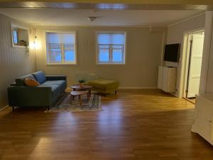 a living room with a couch and a table at Apartment Svolvær in Svolvær