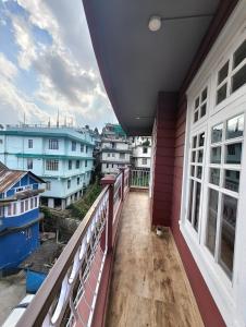 a balcony with a view of a city at The Ark Guest House - Shillong in Shillong