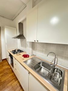 a kitchen with a sink and a stove at Apartment San Valentino in Rome