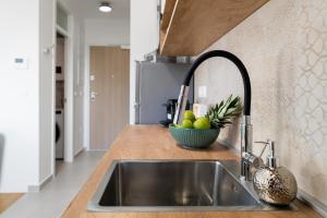a kitchen with a sink and a bowl of fruit at Tres Fenestras Zadar - private parking in Zadar +19 photos