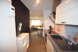 a kitchen with a sink and a counter top at EG Ferienwohnung Merzig Stadt 60 qm PKW Stellplatz im Innenhof in Merzig