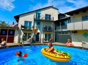 a group of children playing in a swimming pool at Landgasthof und Pension Zum löwen in Bischofsheim an der Rhön