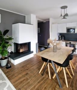 a living room with a table and a fireplace at Villa Eckhart in Göhren