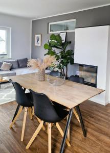 a dining room table and chairs in a living room at Villa Eckhart in Göhren