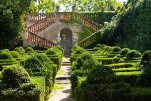 an old house with a staircase in a garden at The Upscale Inn in Srinagar