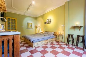 a bedroom with a bed and a checkered floor at 1- Homestay Hanoi- Cozy - Street view - Perfect Location in Hanoi