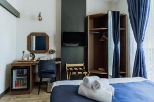 a bedroom with a bed and a desk and a chair at The Rest Port Hotel in Edirne