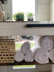 a pile of towels on a shelf next to a window at La Casa de Caro Playa in Mar de Cobo +11 photos