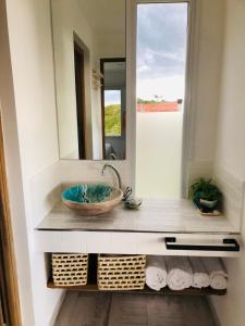 a bathroom with a bowl sink and a mirror at La Casa de Caro Playa in Mar de Cobo
