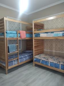 a room with three bunk beds with blue beds at Buddha Hostel in Chişinău