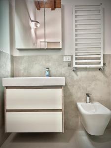 a bathroom with a white sink and a toilet at Da Carlin in Cesena