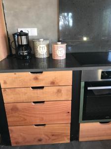 a kitchen with a black counter top and a stove at Waka Sun Set PICO AZORES in São Roque do Pico