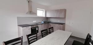 a kitchen with a table and a table and chairs at Pension Lahntal in Goßfelden
