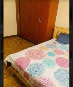 a bedroom with a bed with colorful designs on it at Katabi Green Escape in Entebbe