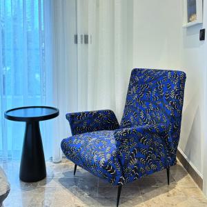 a blue chair and a table in a room at Misk Villa - Boutique Hotel & Spa in Sidi Bou Saïd