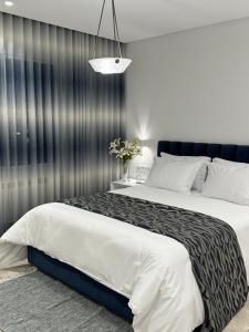 a bedroom with a large bed and a wall at Misk Villa - Boutique Hotel & Spa in Sidi Bou Saïd