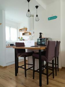 a dining room table with two chairs and a microwave at Moderne & au centre - Studio in Lorient