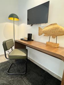 a desk with a fish sculpture and a chair at Misk Villa - Boutique Hotel & Spa in Sidi Bou Saïd