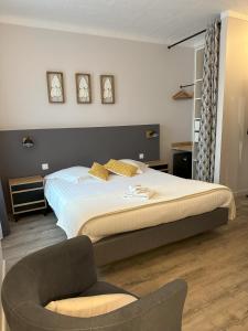 a bedroom with a large bed and a chair at Dolce Vita in Mondorf-les-Bains