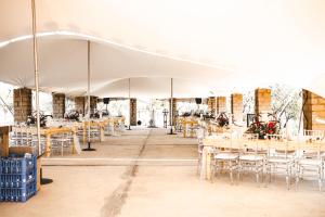a large white tent with tables and chairs at Buffalo Ranch Game Lodge in Groblersdal