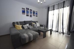 a living room with a couch and a table at Edimar 9 - Fincas Arena in Benidorm