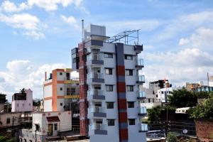 a tall white building with balconies on top of it at Shankar Residency, Akkalkot in Akalkot